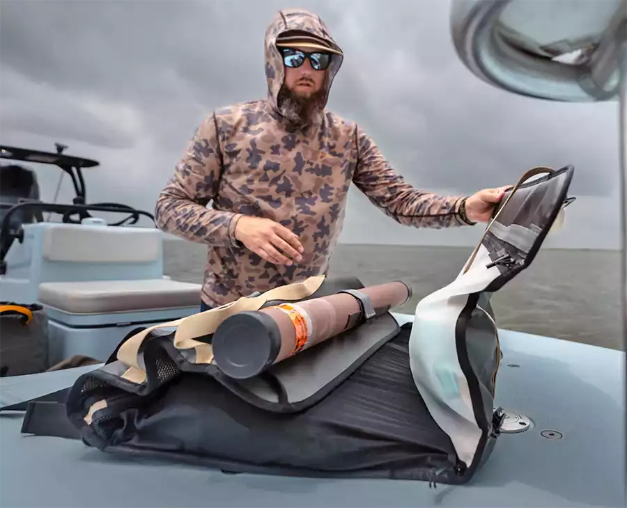 Angler packing his Riversmith Convoy Gear Roll