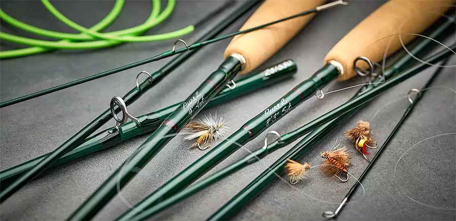 Winston PURE 2 fly rods laying on a table with flies