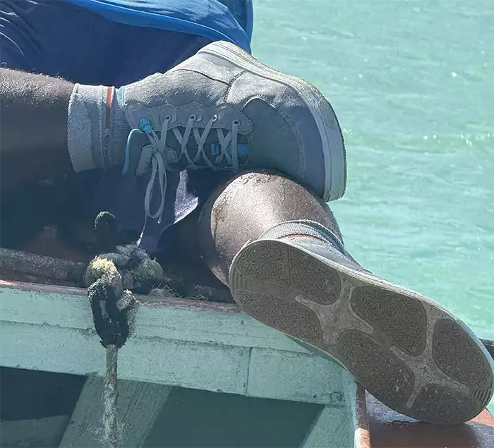 Guide wearing the Korkers Salt Sneaker Boots on the deck of the boat