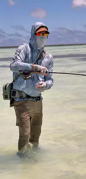 Chris King wading and fighting a fish at Christmas Island