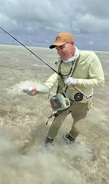 Chris King holding a bonefish at Christmas Island