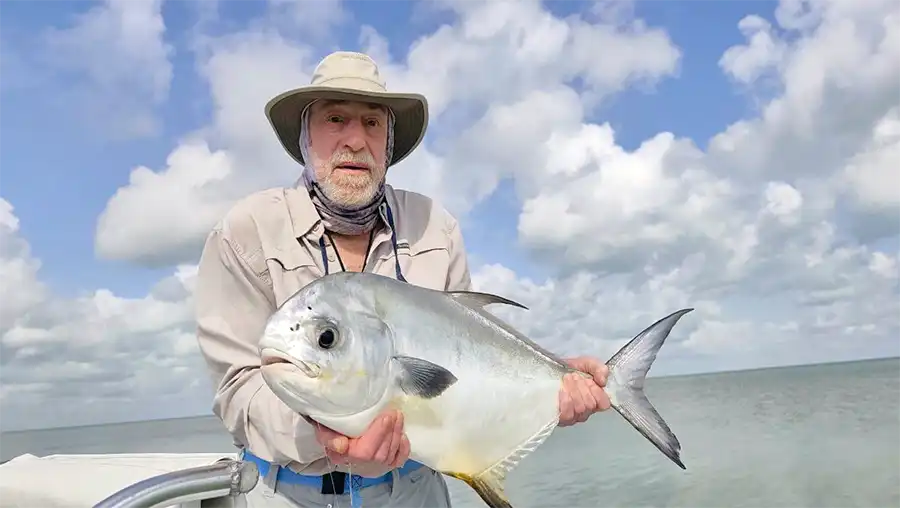 Angler holding a permit at ESB Lodge