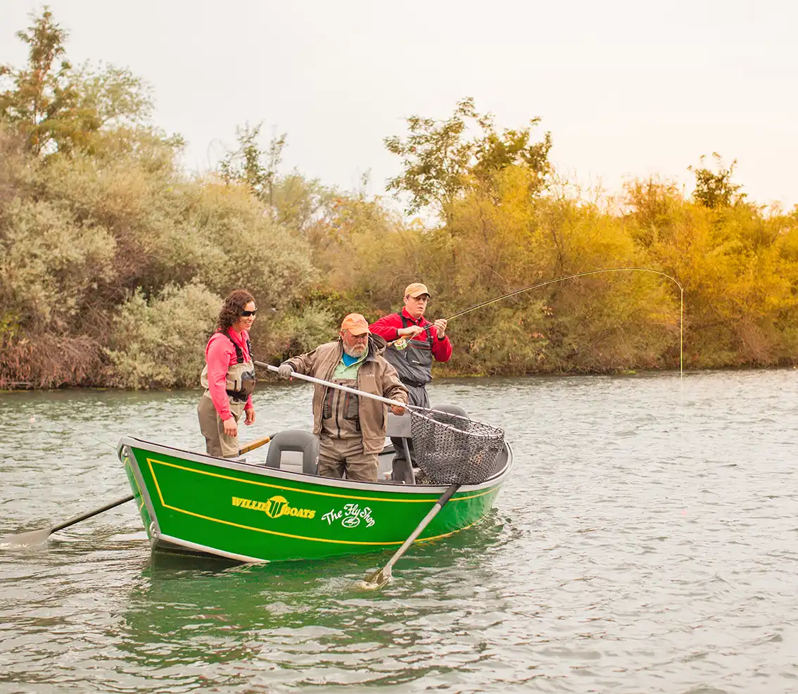 Angler fighting a fish from a drift boat on the Lower Sacramento River - Marcel Siegle photo
